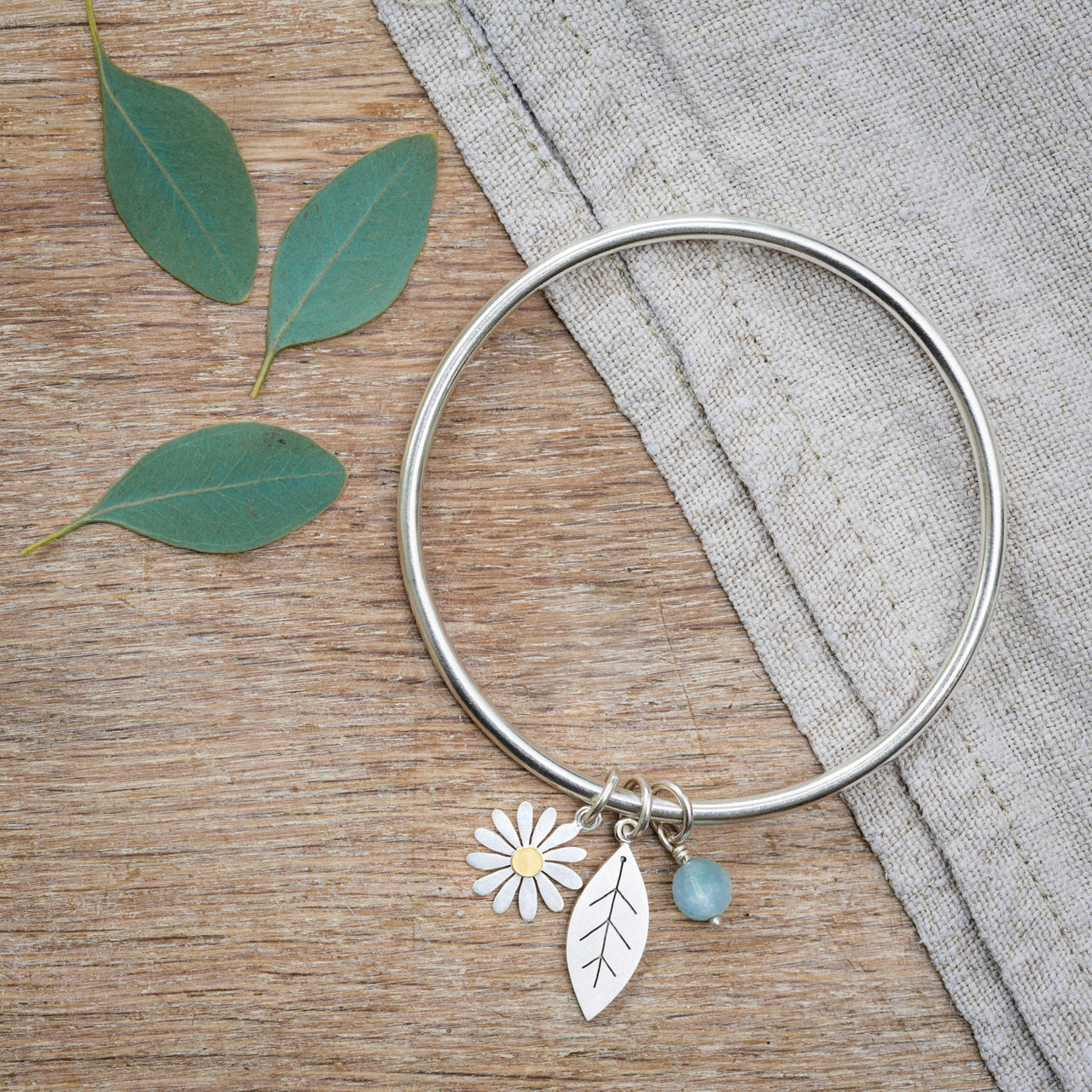 Sterling Silver Bangle, with Silver, 18ct Gold & Aquamarine Charms